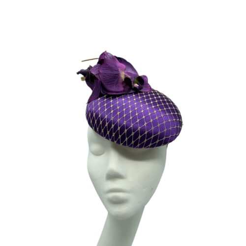 Stunning purple headpiece with matching orchid flower detail and finished with a gold veiling overlay on the base.